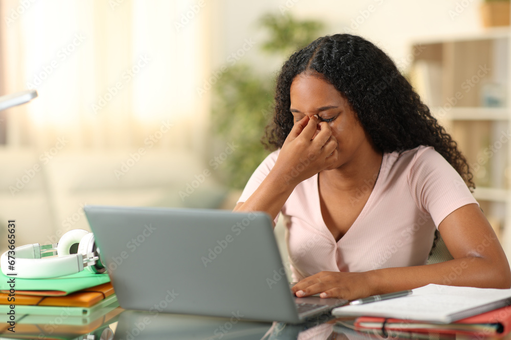 Black student suffering eyestrain e-learning at home Black student suffering eyestrain e-learning at home