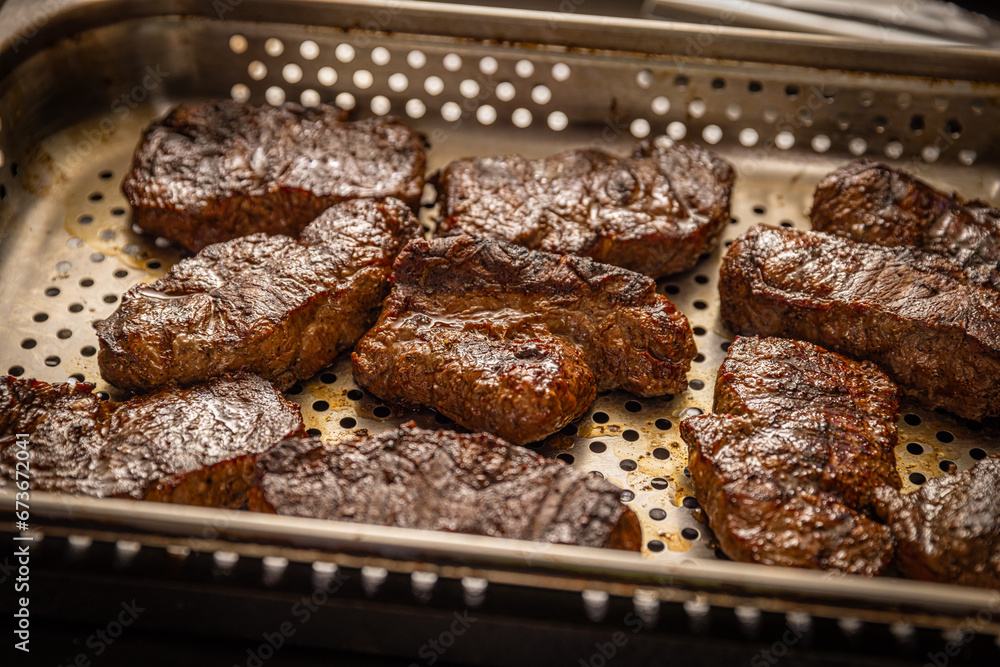 Pieces of grilled steak with fat Pieces of grilled steak with fat