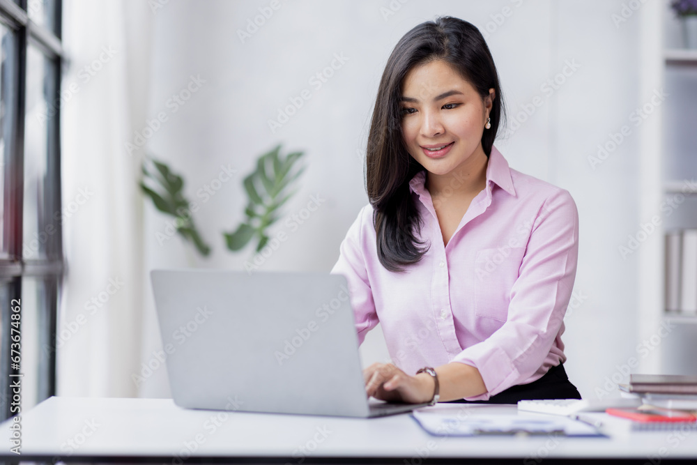 Business asian woman using calculator for do math finance in the office and business working background, tax, accounting, statistics and analytic research concept Business asian woman using calculator for do math finance in the office and business working background, tax, accounting, statistics and analytic research concept