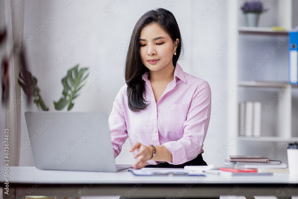 Business asian woman using calculator for do math finance in the office and business working background, tax, accounting, statistics and analytic research concept Business asian woman using calculator for do math finance in the office and business working background, tax, accounting, statistics and analytic research concept