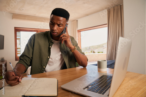 Tableau sur toile Young adult black male concerned, taking notes while on cellphone