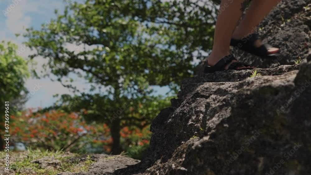 Side view of girl jumping on big rocks, slow motion Side view of girl jumping on big rocks, slow motion