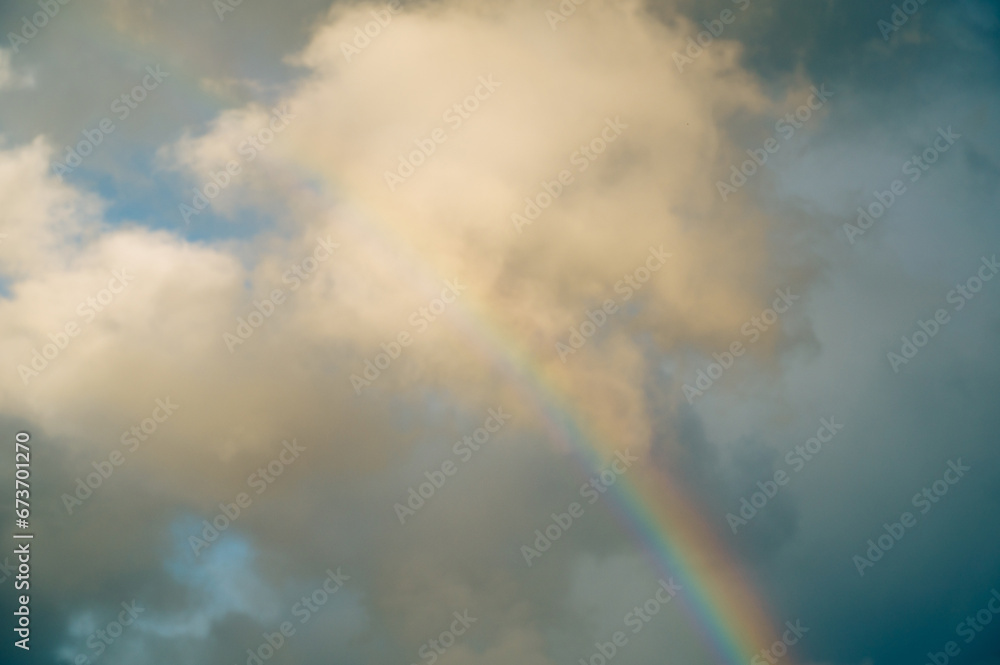 Obraz premium Rainbow in the sky, clouds, stormy and rainy weather, natural phenomena
