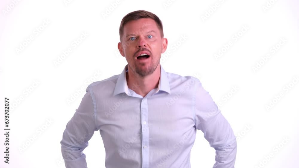 Funny male worker makes faces standing on white background in light studio. Concept of cheerful emotions and foolishness in adulthood Funny male worker makes faces standing on white background in light studio. Concept of cheerful emotions and foolishness in adulthood