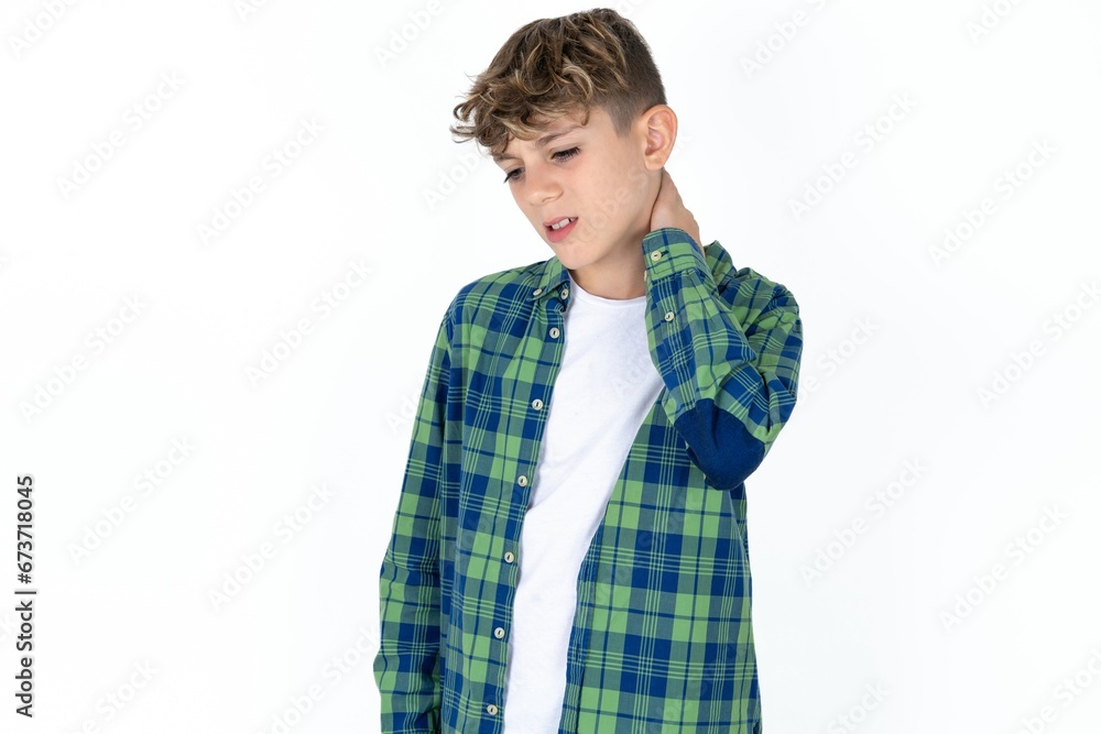 Caucasian teen boy Suffering of neck ache injury, touching neck with hand, muscular pain Caucasian teen boy Suffering of neck ache injury, touching neck with hand, muscular pain