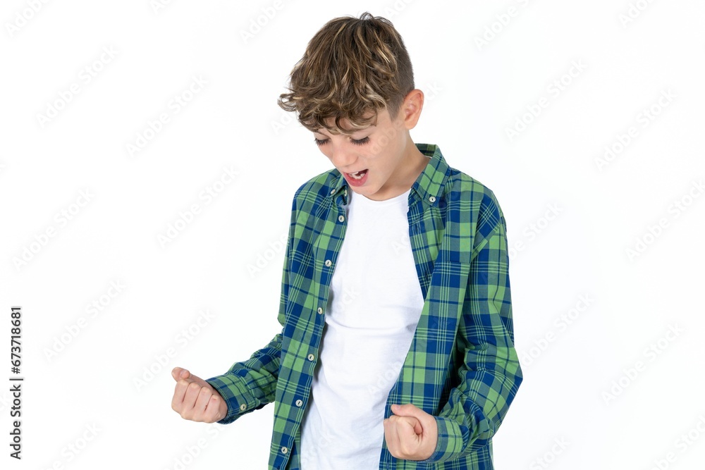 Caucasian teen boy very happy and excited doing winner gesture with arms raised, smiling and screaming for success. Celebration concept. Caucasian teen boy very happy and excited doing winner gesture with arms raised, smiling and screaming for success. Celebration concept.