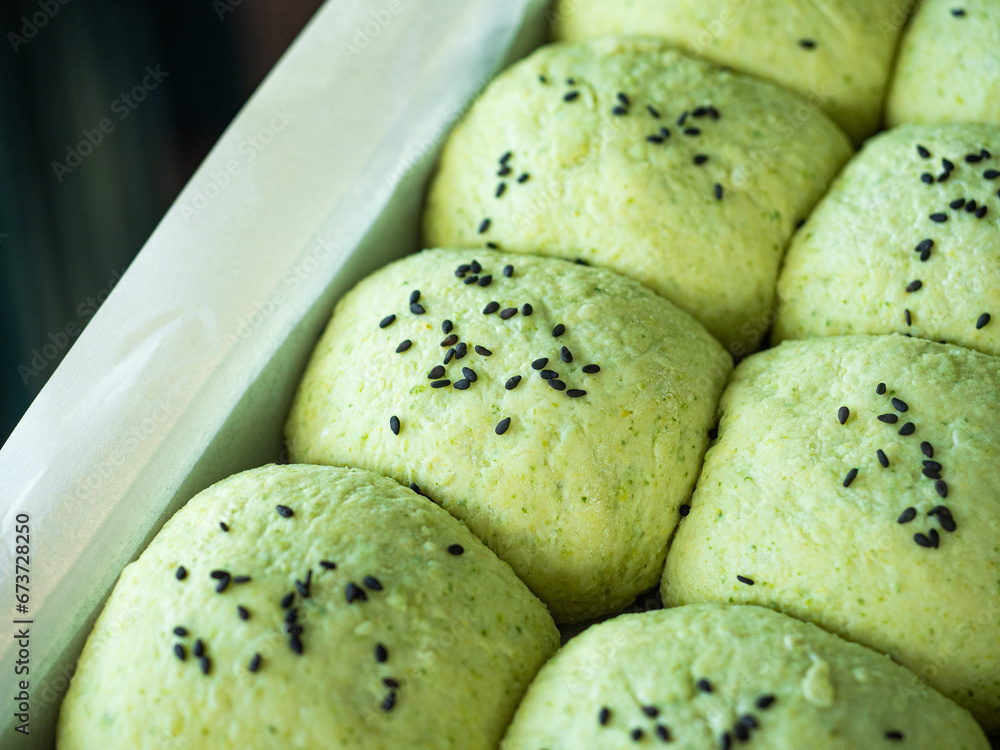 green bread rolls with black sesame seed topping green bread rolls with black sesame seed topping
