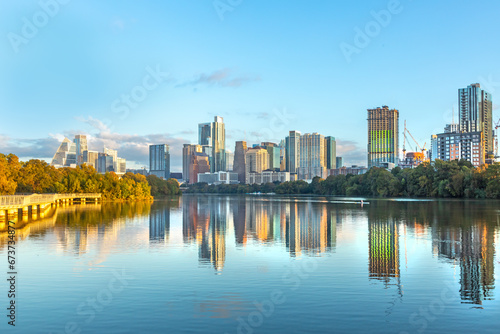 skyline of Austin in early morning light with mirroring city in the colorado river, Texas