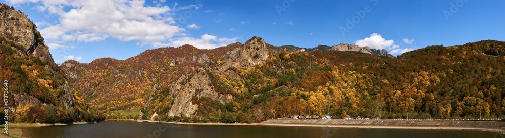 Vibrant landscape with autumn forests and lake