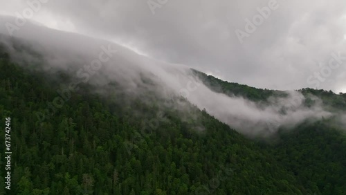 Fog and mist spill over remote forested mountain in Hokkaido, Japan