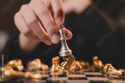 Close up hand Chess business concept. Businessman moving chess piece on chess board game for ideas and competition and strategy, business success concept, business competition concept.