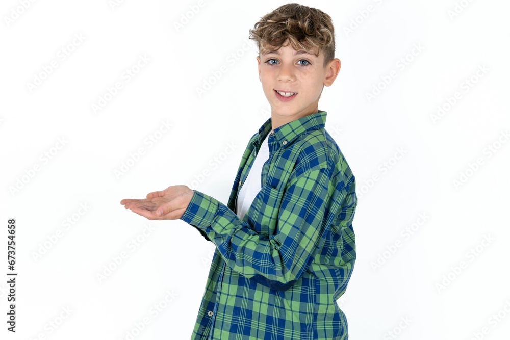 Caucasian teen boy pointing aside with hands open palms showing copy space, presenting advertisement smiling excited happy Caucasian teen boy pointing aside with hands open palms showing copy space, presenting advertisement smiling excited happy
