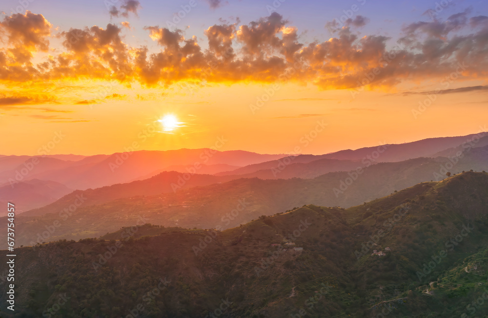 Obraz premium summer scenery mountain view from a highland hill to a beautiful sunset.