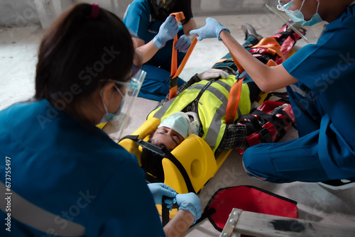 First aid for injuries from accidents in construction work, Loss of feeling or normal movement and Loss of function in limbs, First aid training to transfer patients, Tools for EMTs or Paramedics. photo