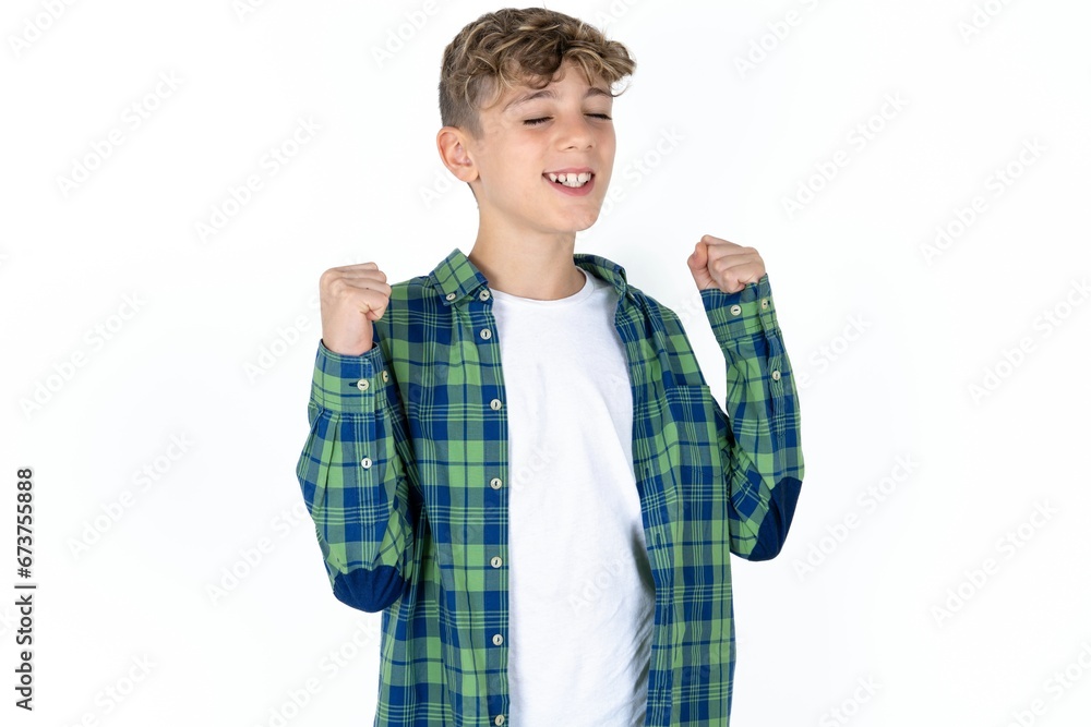 Ecstatic Caucasian teen boy shout loud yeah fist up raise win lottery Ecstatic Caucasian teen boy shout loud yeah fist up raise win lottery