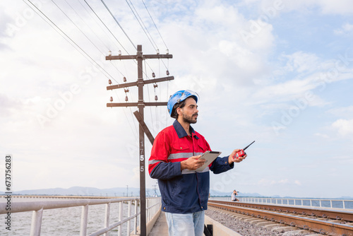 Engineer railway wearing safety uniform and helmet under checking railway. construction worker on railways. Engineer work on Railway.