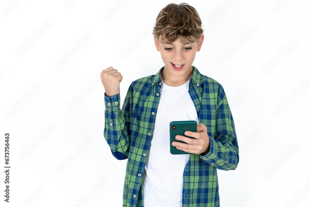 Portrait of Caucasian teen boy holding in hands cell celebrating Portrait of Caucasian teen boy holding in hands cell celebrating