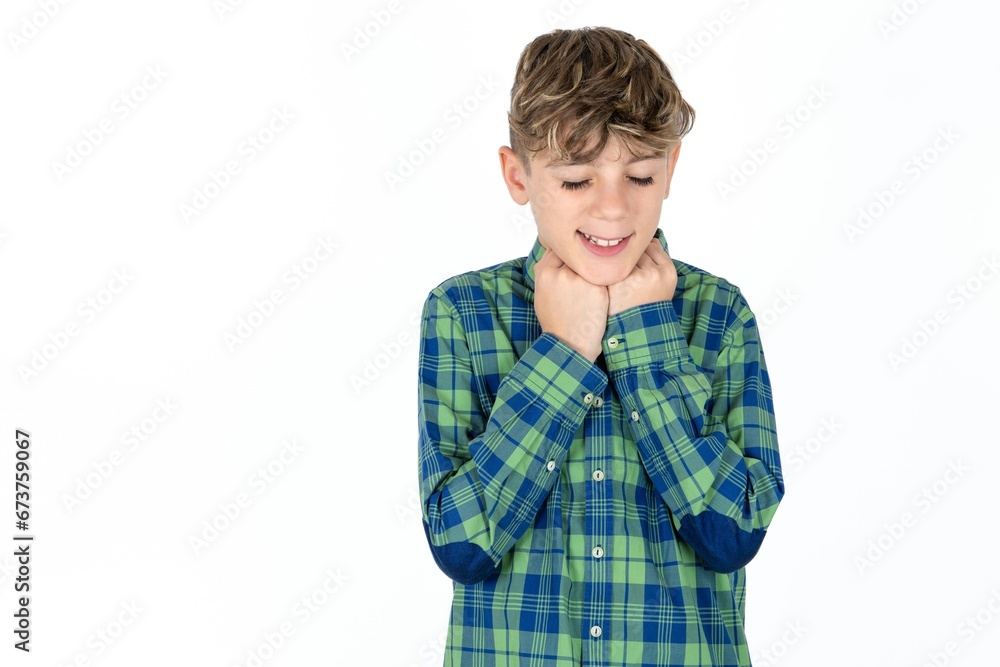 Cheerful Caucasian teen boy wearing plaid shirt has shy satisfied expression, smiles broadly, shows white teeth, People emotions Cheerful Caucasian teen boy wearing plaid shirt has shy satisfied expression, smiles broadly, shows white teeth, People emotions