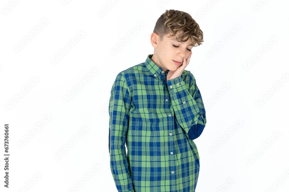 Caucasian teen boy wearing plaid shirt with toothache Caucasian teen boy wearing plaid shirt with toothache
