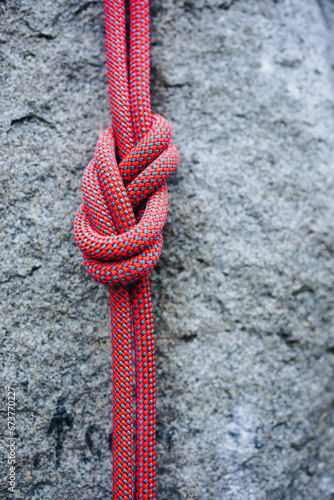 eight climbing knot with colorful rope on rocky background