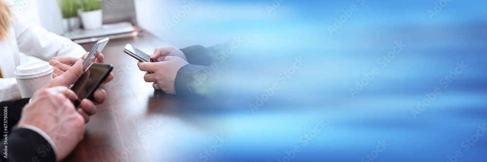Group of people using and looking at mobile phone; panoramic banner Group of people using and looking at mobile phone; panoramic banner