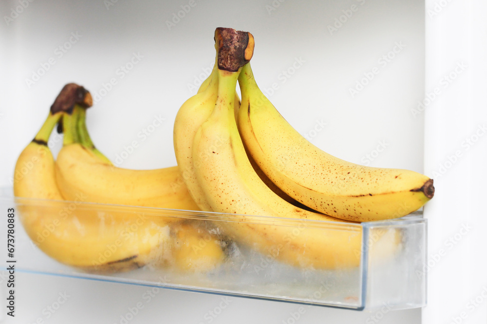 Bananas in fridge. Isolated on white fridge door. Yellow fruit with