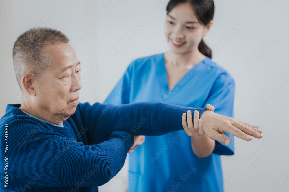 Fototapeta premium Asian female doctor or nurse exercising with elderly man at hospital