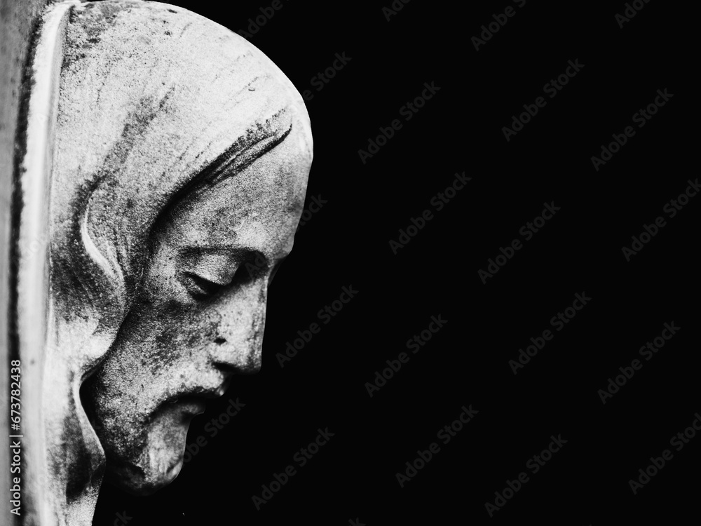 Face of Jesus Christ in profile on a black background. Black and white image of ancient statue. Copy space. Face of Jesus Christ in profile on a black background. Black and white image of ancient statue. Copy space.