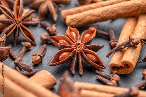 Lots of three spices for mulled wine – star anise, cinnamon and clove, macro.