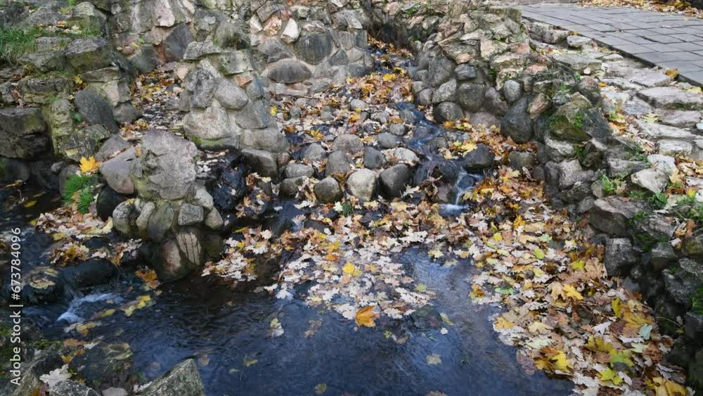 Small decorative cascade in old public park at autumn season Small decorative cascade in old public park at autumn season