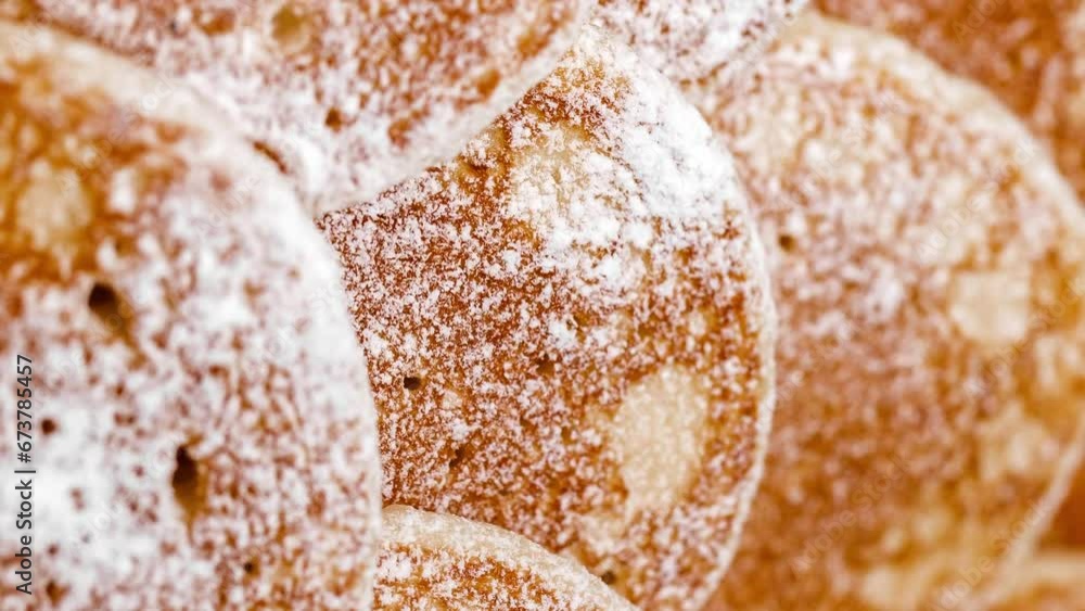 Pancakes sprinkled with powdered sugar, rotating, turning, close-up macro, top view, selective focus
Pancakes sprinkled with powdered sugar, rotating, turning, close-up macro, top view, selective focus