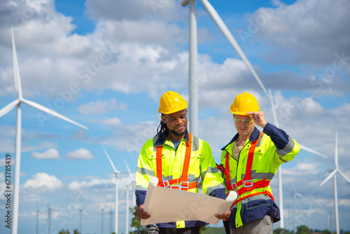 Wind turbine Engineers working in wind turbine farm , Green ecological Sustainable energy industry concept, Wind turbine Engineers working in wind turbine farm