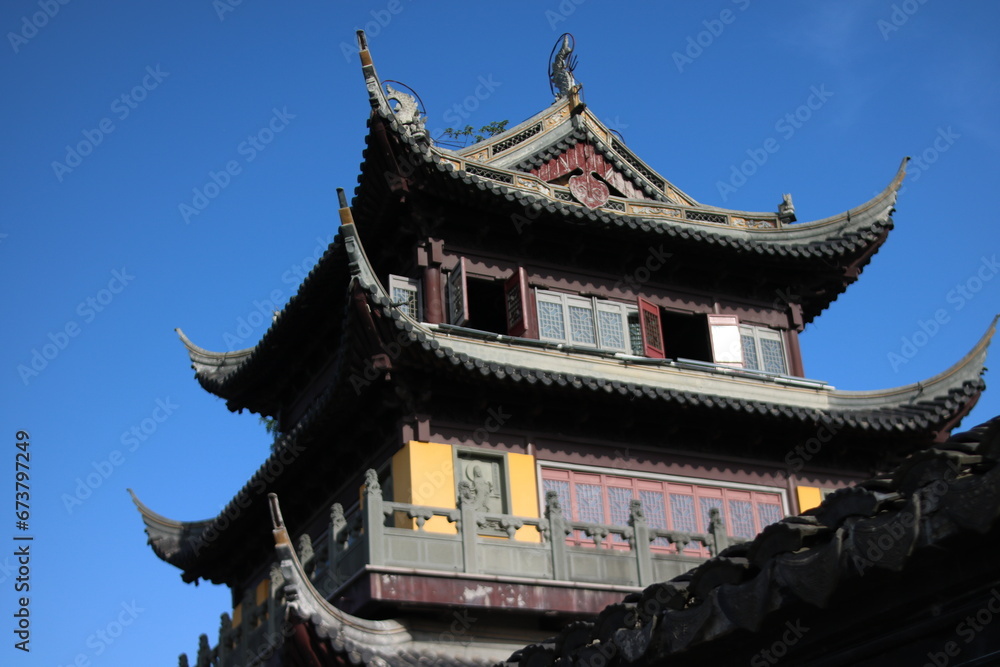 chinese temple building a golden Buddhist temple stands vibrant against a clear blue sky in Zhujiajiao, China.