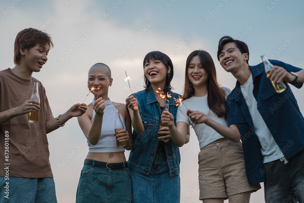 Image of group of friends celebrating and drinking beer together Image of group of friends celebrating and drinking beer together