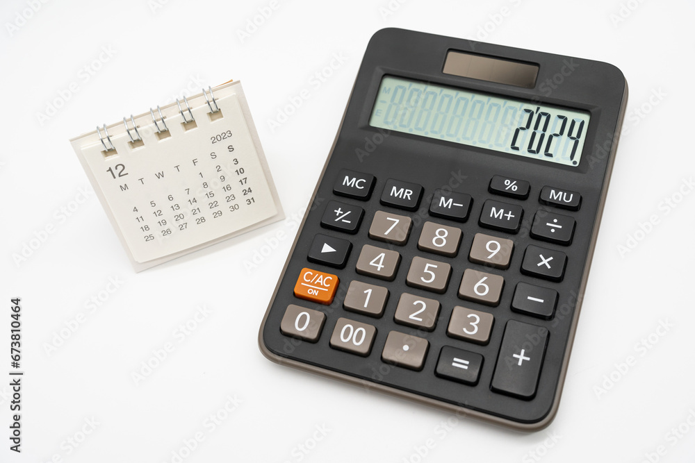 Calculator with the number 2024 on the display and Calendar DEC 2023. Concept of finance, taxes, savings and economic crisis. schedule, timetable and management of job. Business and tax concept. Calculator with the number 2024 on the display and Calendar DEC 2023. Concept of finance, taxes, savings and economic crisis. schedule, timetable and management of job. Business and tax concept.