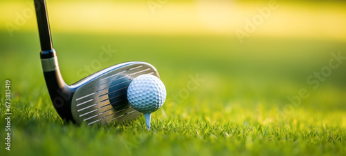 Closeup of golf club and golf ball on green grass photo