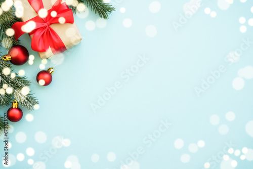 Christmas present box and decorations with holiday frame. Flat lay image with copy space.