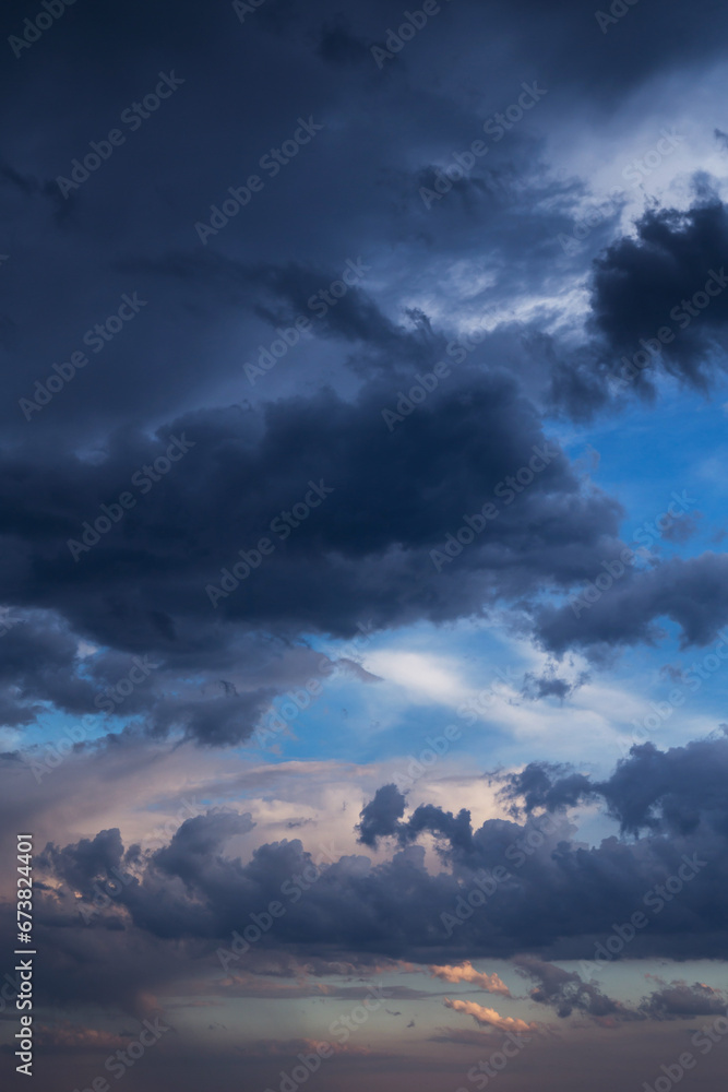 Epic Dramatic storm dark blue grey cumulus rain clouds on blue sky background, thunderstorm