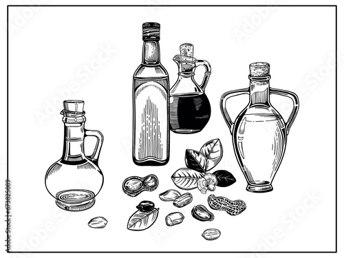 Composition with oil bottles and a sprig of peanuts with leaves and a flower, peanut nuts.