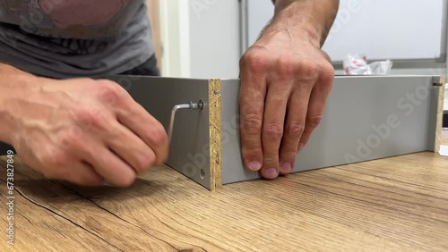 Assembling furniture with men's hands