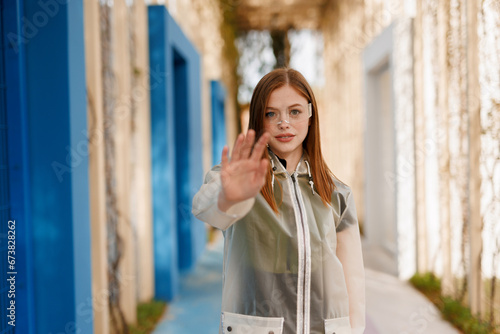 Woman in futuristic costume in the park. Female in modern VR glasses interacting with network while having virtual reality experience. © KDdesignphoto