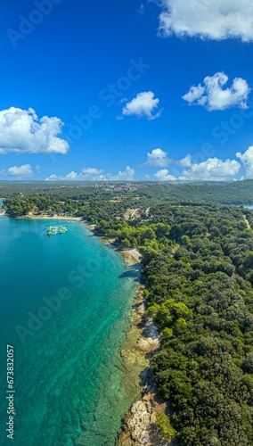 Vertical drone panorama over a stretch of coast near the town of Pula in Istria