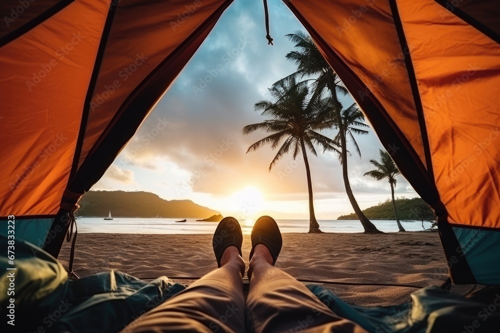 Wide angle first person view from a tent of beautiful sand beach seascape palm tree at sunset. Summer tropical vacation concept.