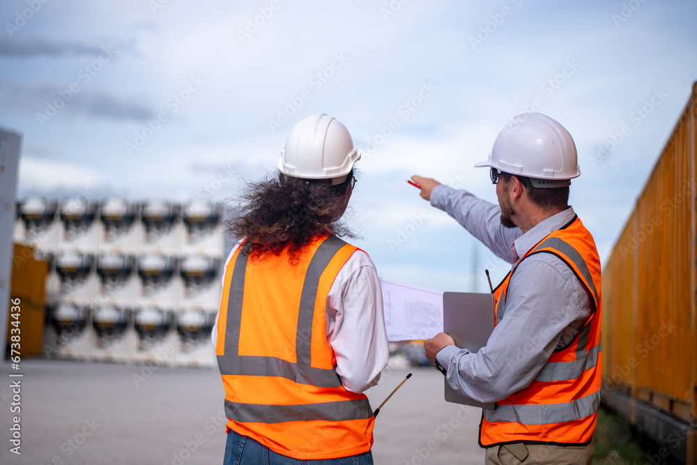 Engineer under discussion inspection and checking construction process railway switch and checking work on railroad station .Engineer wearing safety uniform and safety helmet in work. Engineer under discussion inspection and checking construction process railway switch and checking work on railroad station .Engineer wearing safety uniform and safety helmet in work.