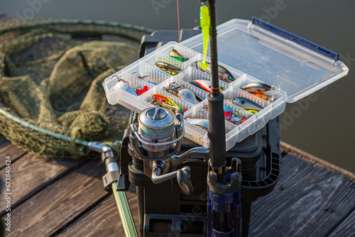 A large fisherman's tackle box fully stocked with lures and gear for fishing.fishing lures and accessories. fishing spinning. Kit of fishing lures. photo