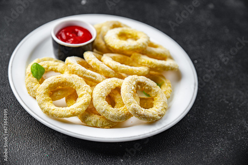 onion rings batter deep fryer tomato sauce fast food eating cooking appetizer meal food snack on the table copy space food background rustic top view