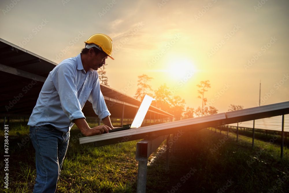 Assistance technical worker in uniform is checking an operation and efficiency performance of photovoltaic solar panels.