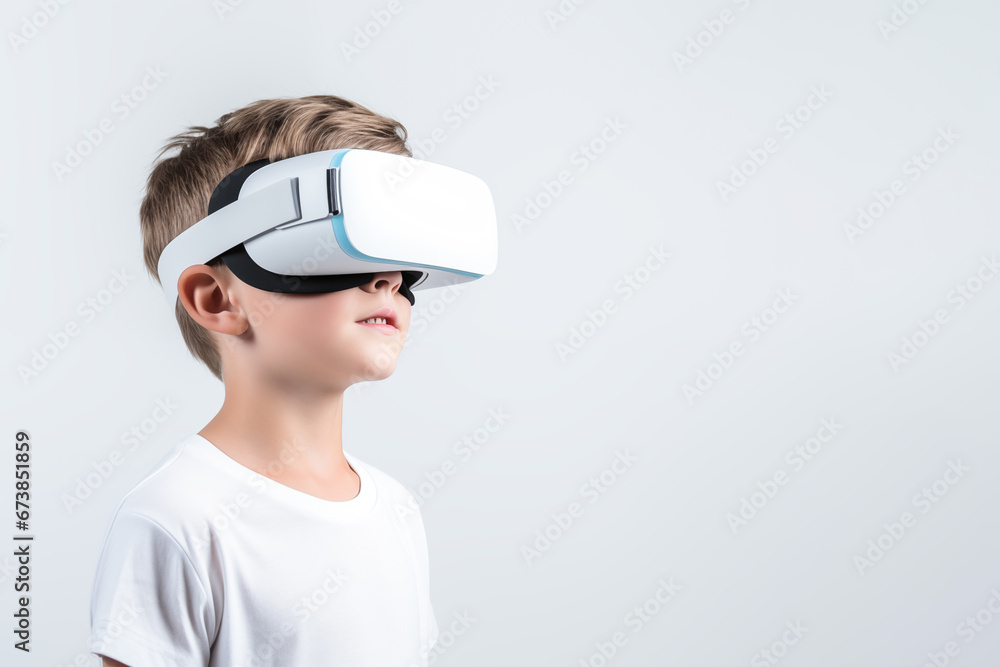 Young boy getting experience using VR headset glasses isolated on a white background with copy space Young boy getting experience using VR headset glasses isolated on a white background with copy space