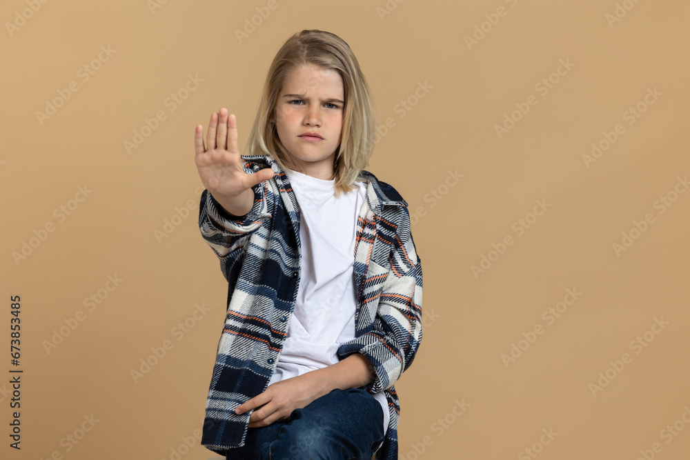 Teen girl putting hands up in a rejecting gesture Teen girl putting hands up in a rejecting gesture