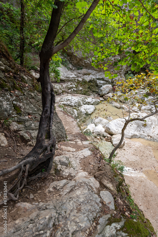 A walking trail following the river bed leading to a waterfall. Nydri waterfall. Lefkada. Greece.
